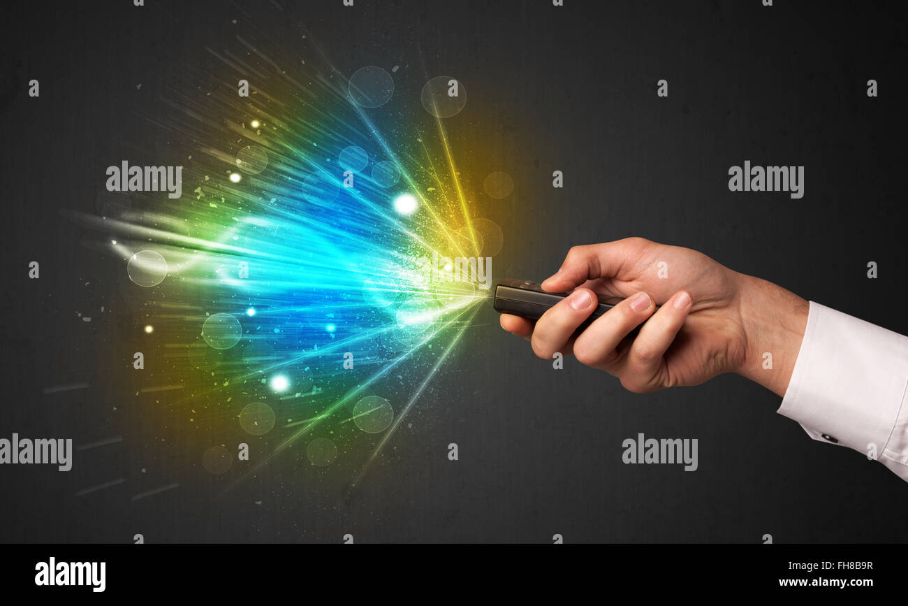 Hand with remote control and explosive signal Stock Photo - Alamy