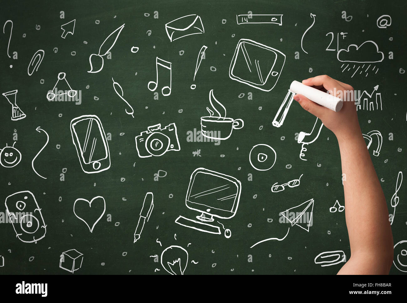 Hand writing icons on blackboard Stock Photo - Alamy