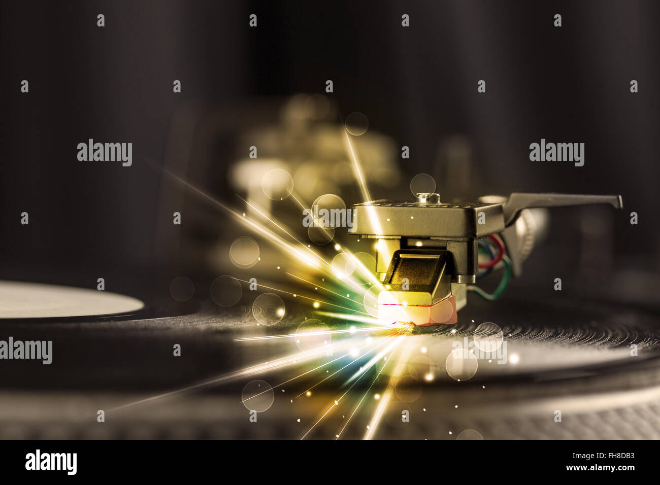 Music player playing vinyl with glow lines comming from the needle Stock Photo