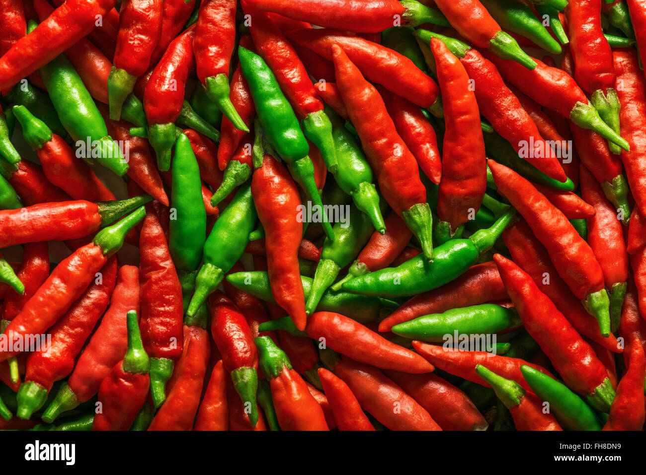 Red and green pepper over flat surface. Stock Photo