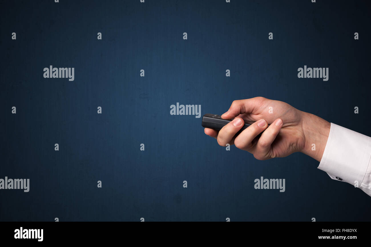 Hand with remote control Stock Photo - Alamy
