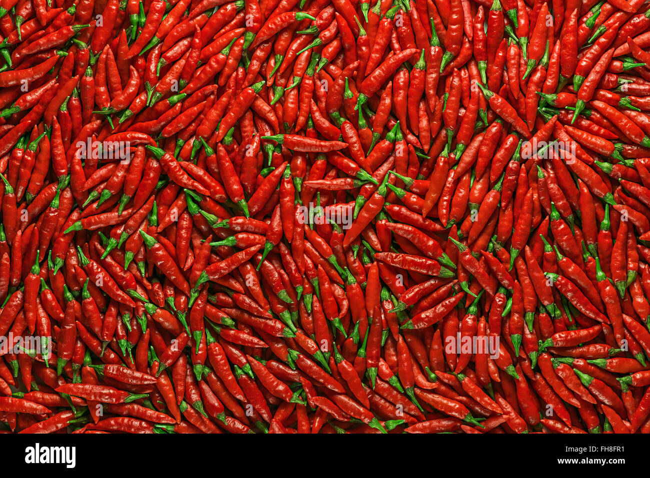 Red peppers on a flat surface. Image for use as background. Stock Photo