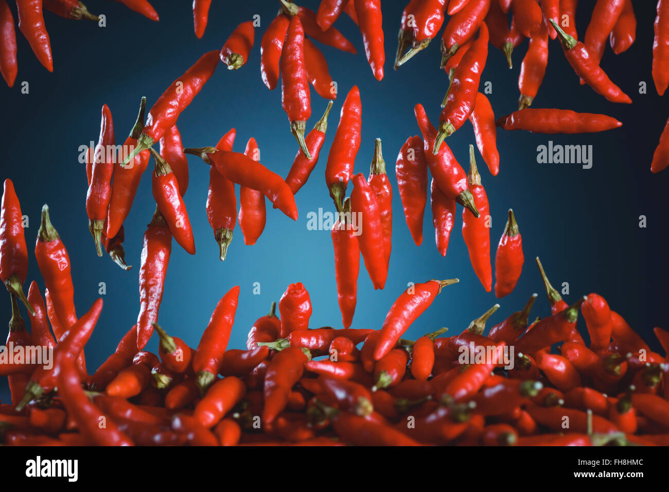 Red peppers falling. Image with depth of field and motion blur. Stock Photo