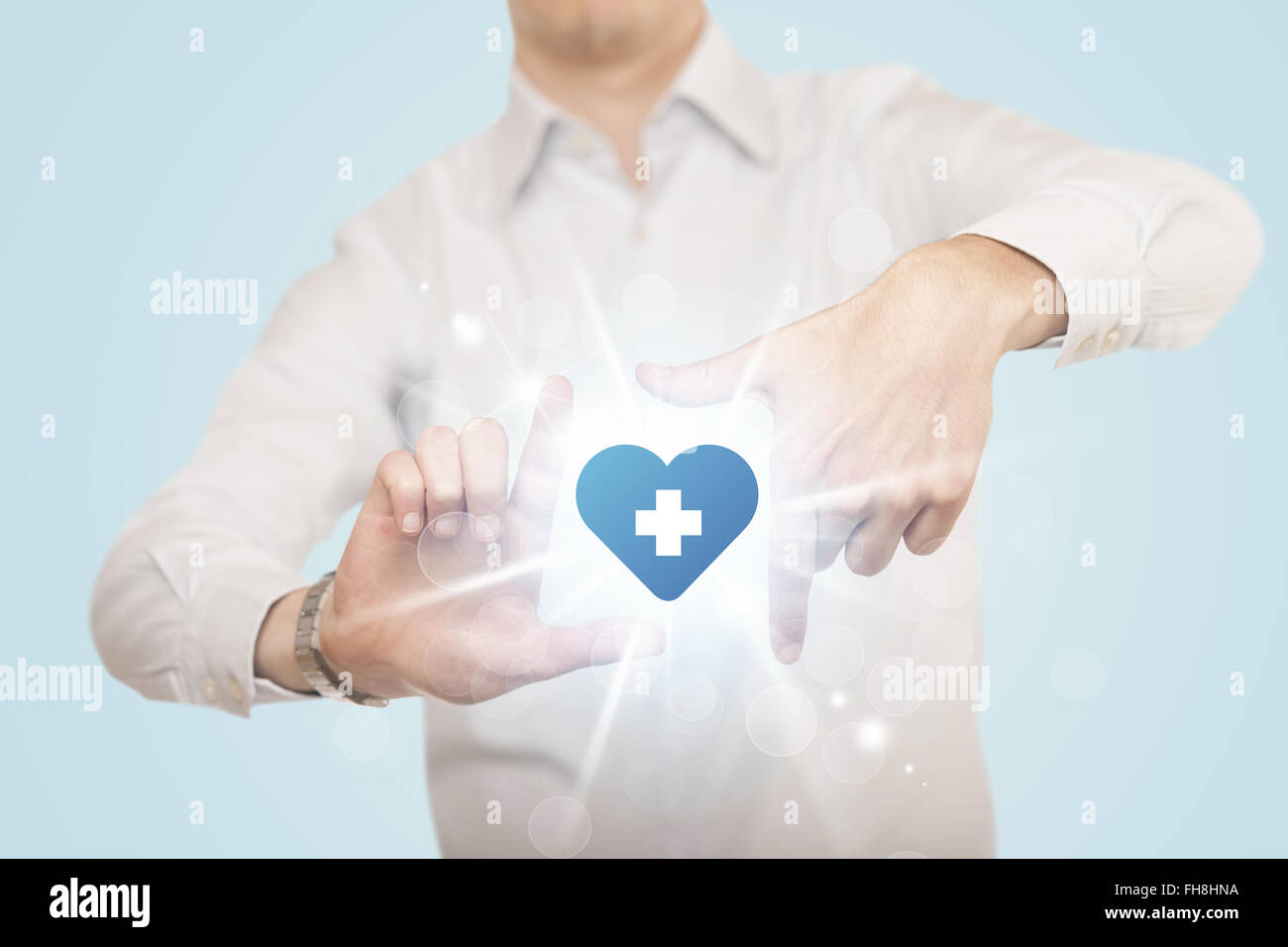 Hands creating a form with heart blue cross Stock Photo