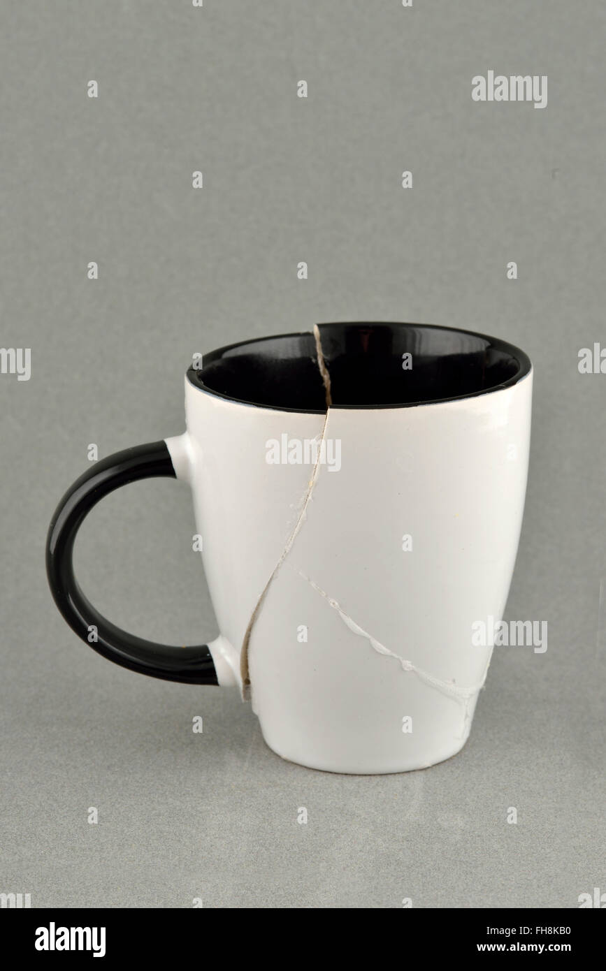 Broken and repaired coffee cup Stock Photo