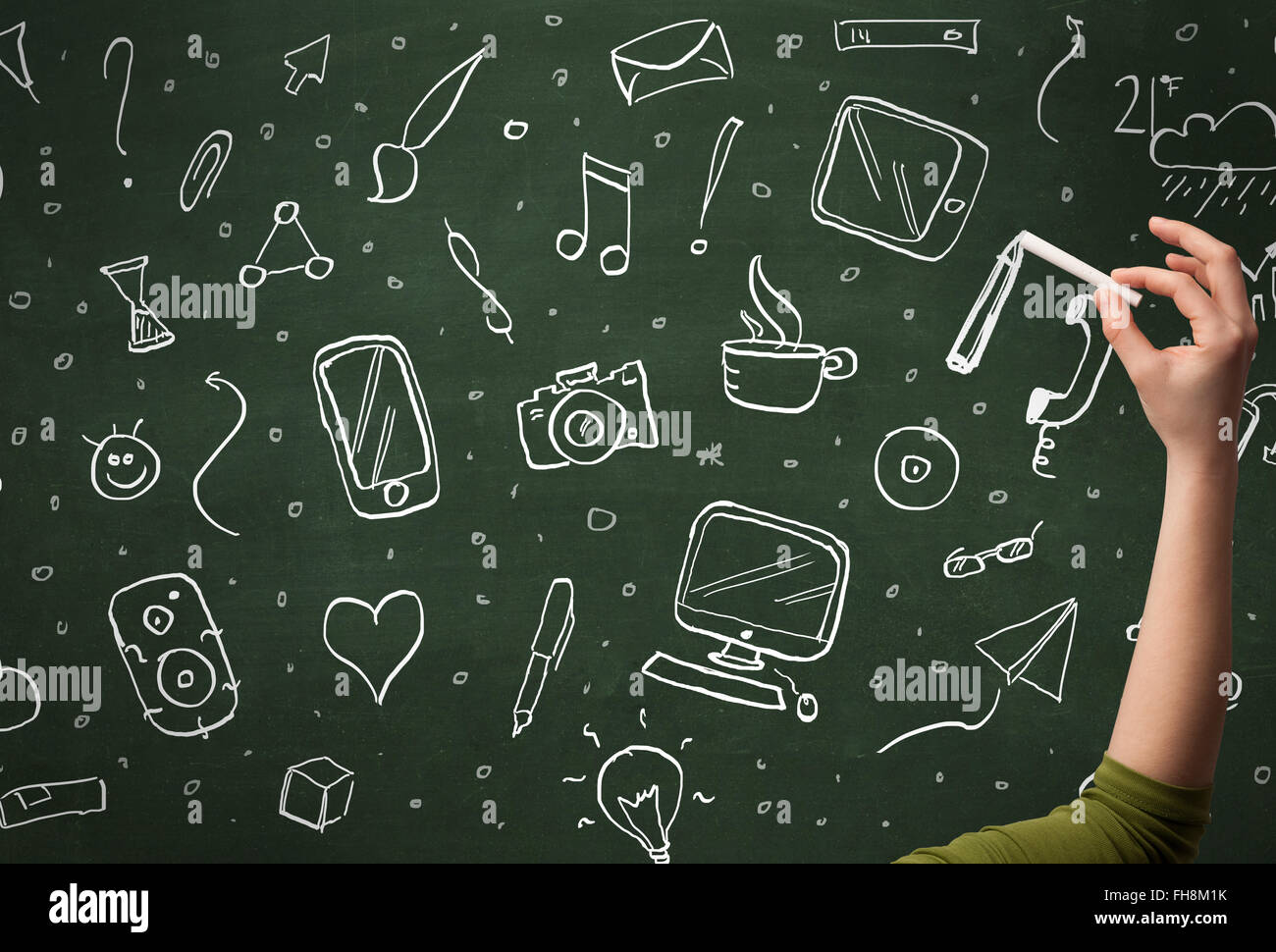 Hand writing icons on blackboard Stock Photo - Alamy