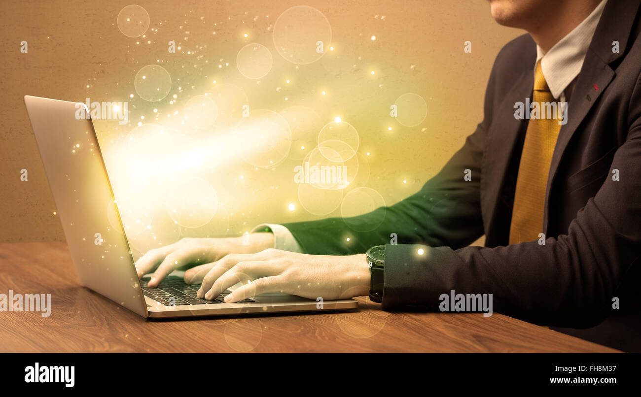 Businessman working fast on laptop Stock Photo - Alamy