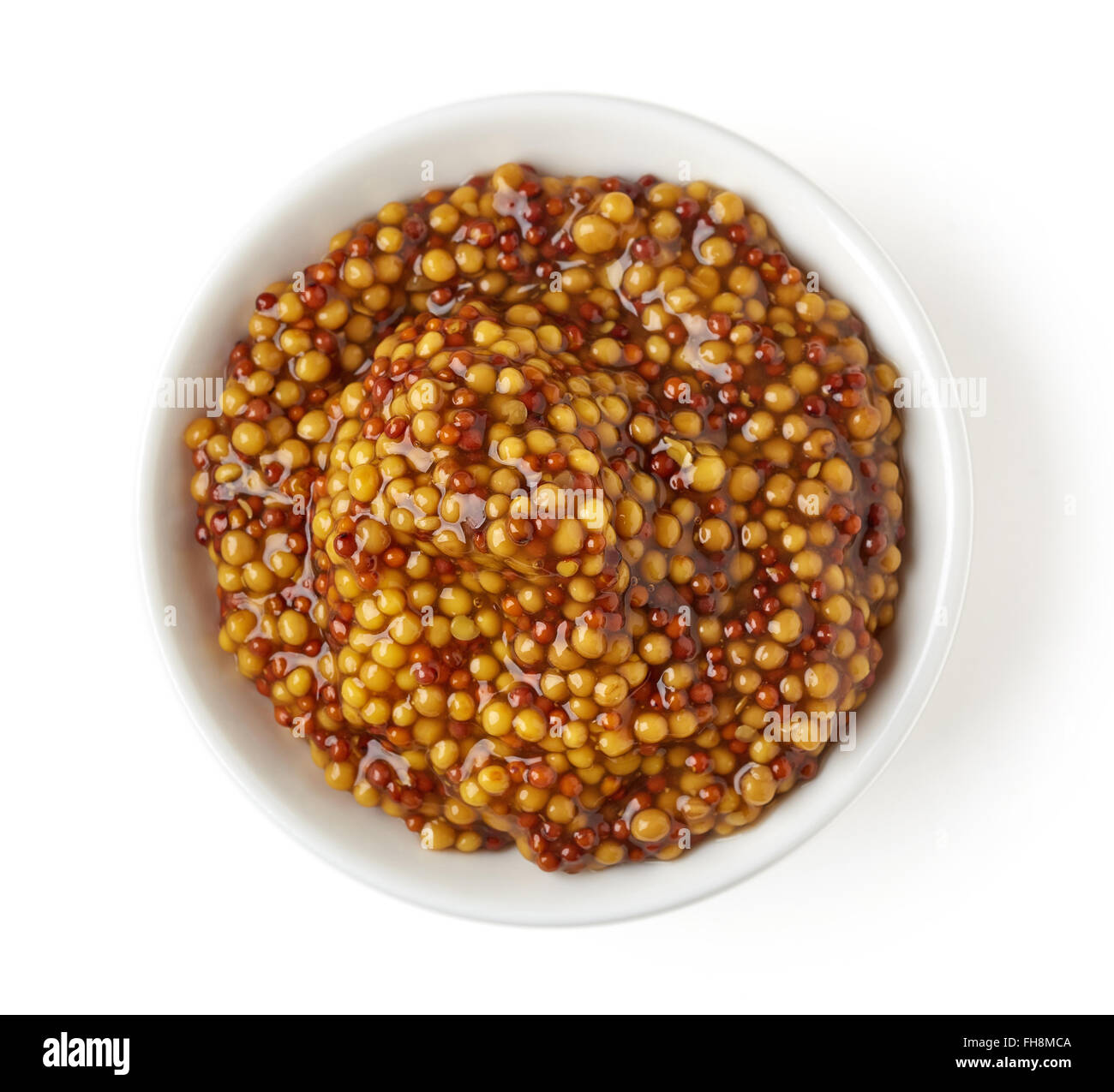 Bowl of full wholegrain mustard on white background, top view Stock Photo
