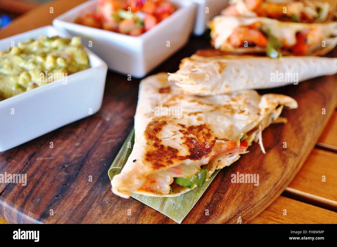 Shrimp quesadillas with guacamole and pico de gallo Stock Photo