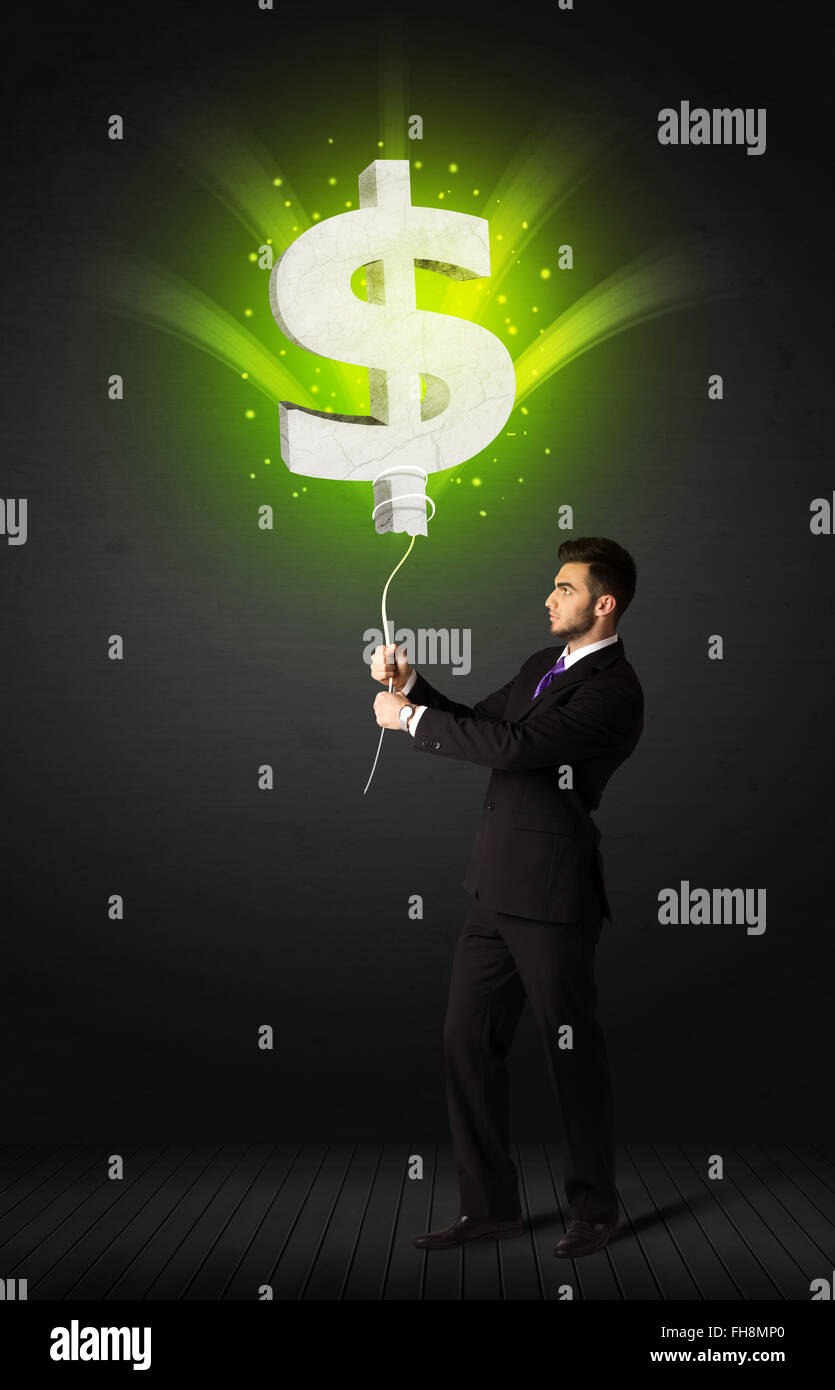Businessman with a dollar sign balloon Stock Photo - Alamy