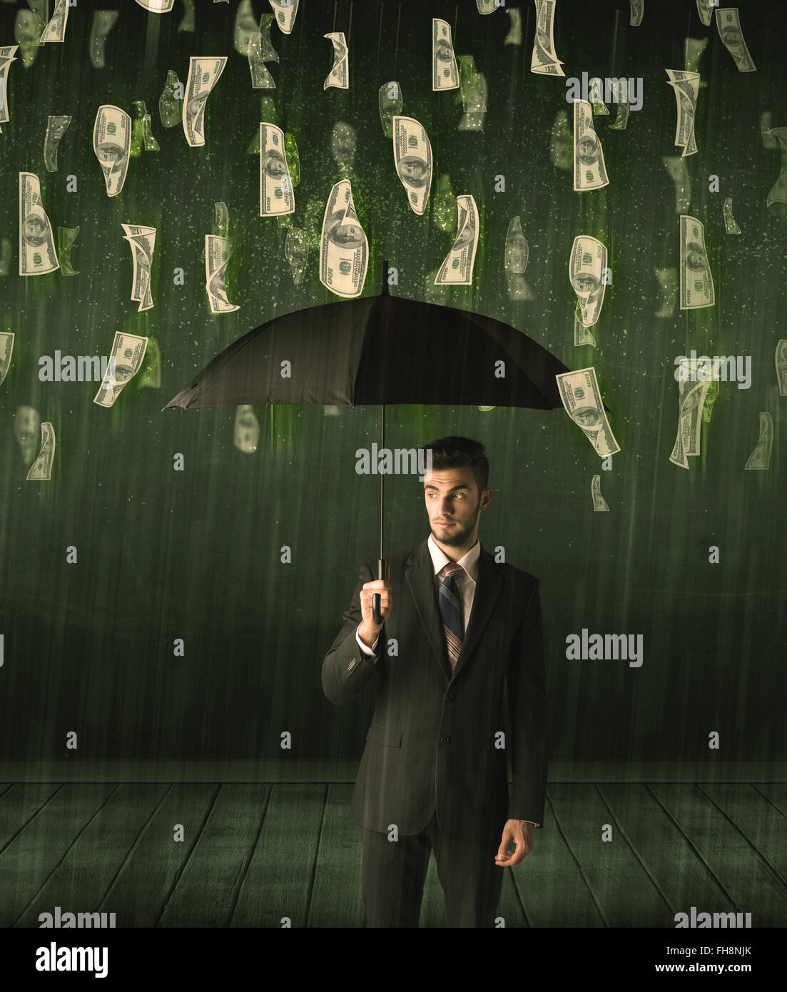 Businessman standing with umbrella in dollar bill rain concept Stock ...