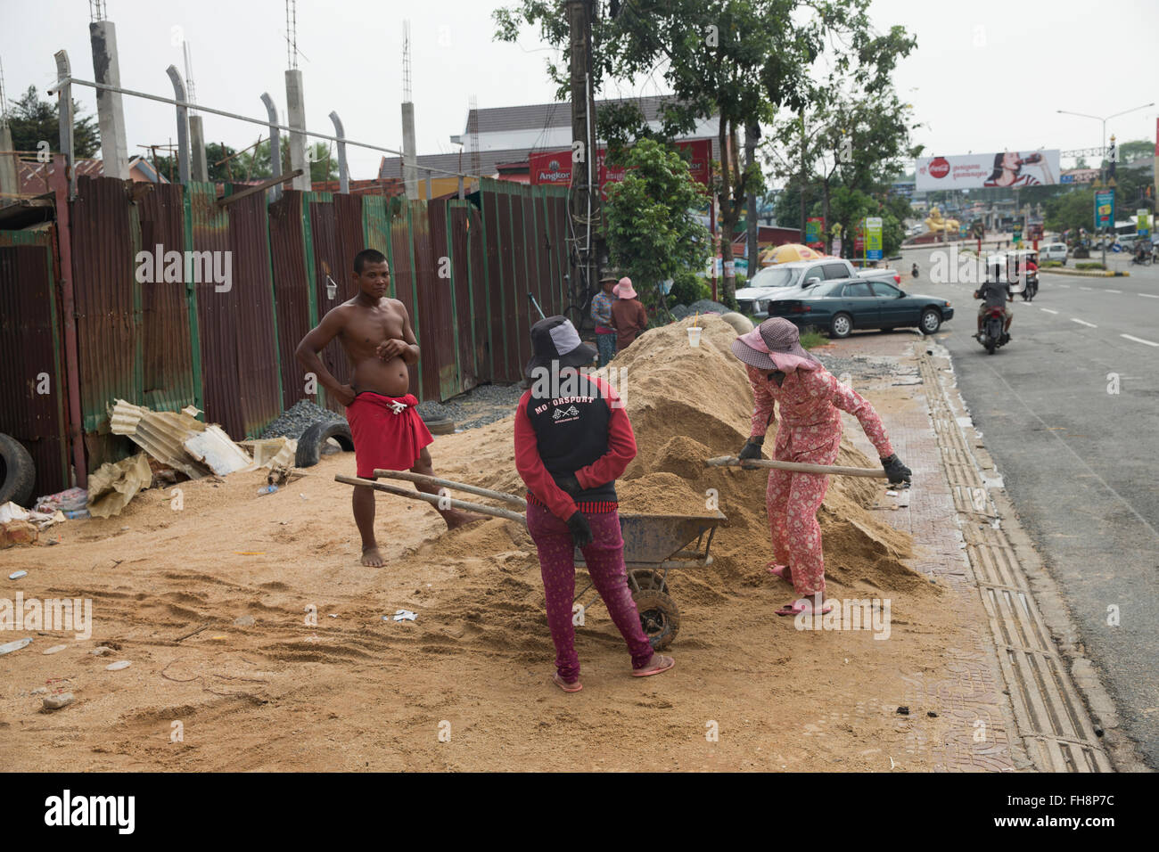 workers on the side of the road in Sihanoukville, Cambodia Stock Photo