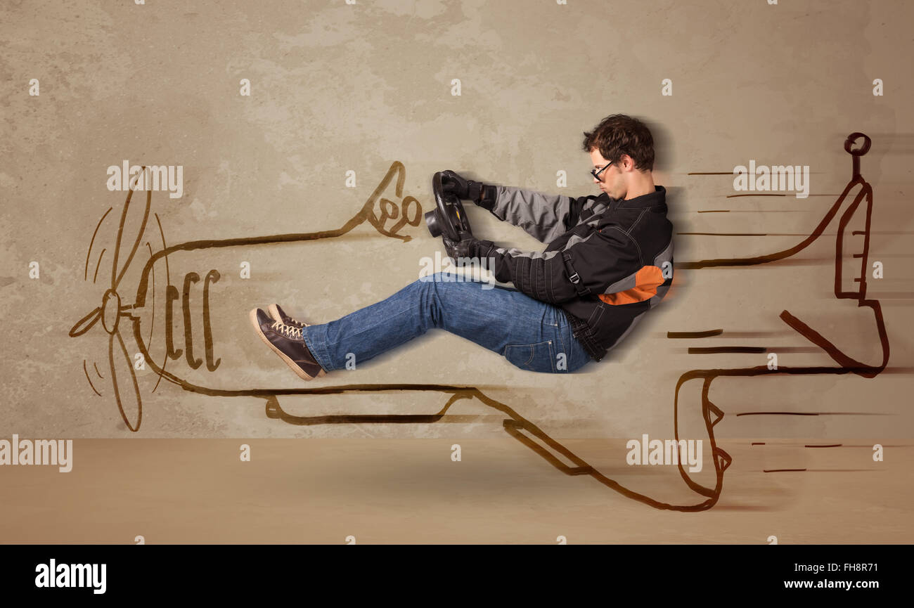 Funny pilot driving a hand drawn airplane on the wall Stock Photo