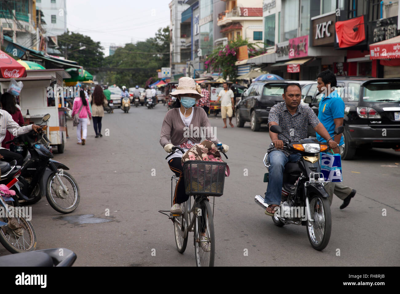street with motorbikes, bicycle and cars in Phnom Penh, Cambodia Stock