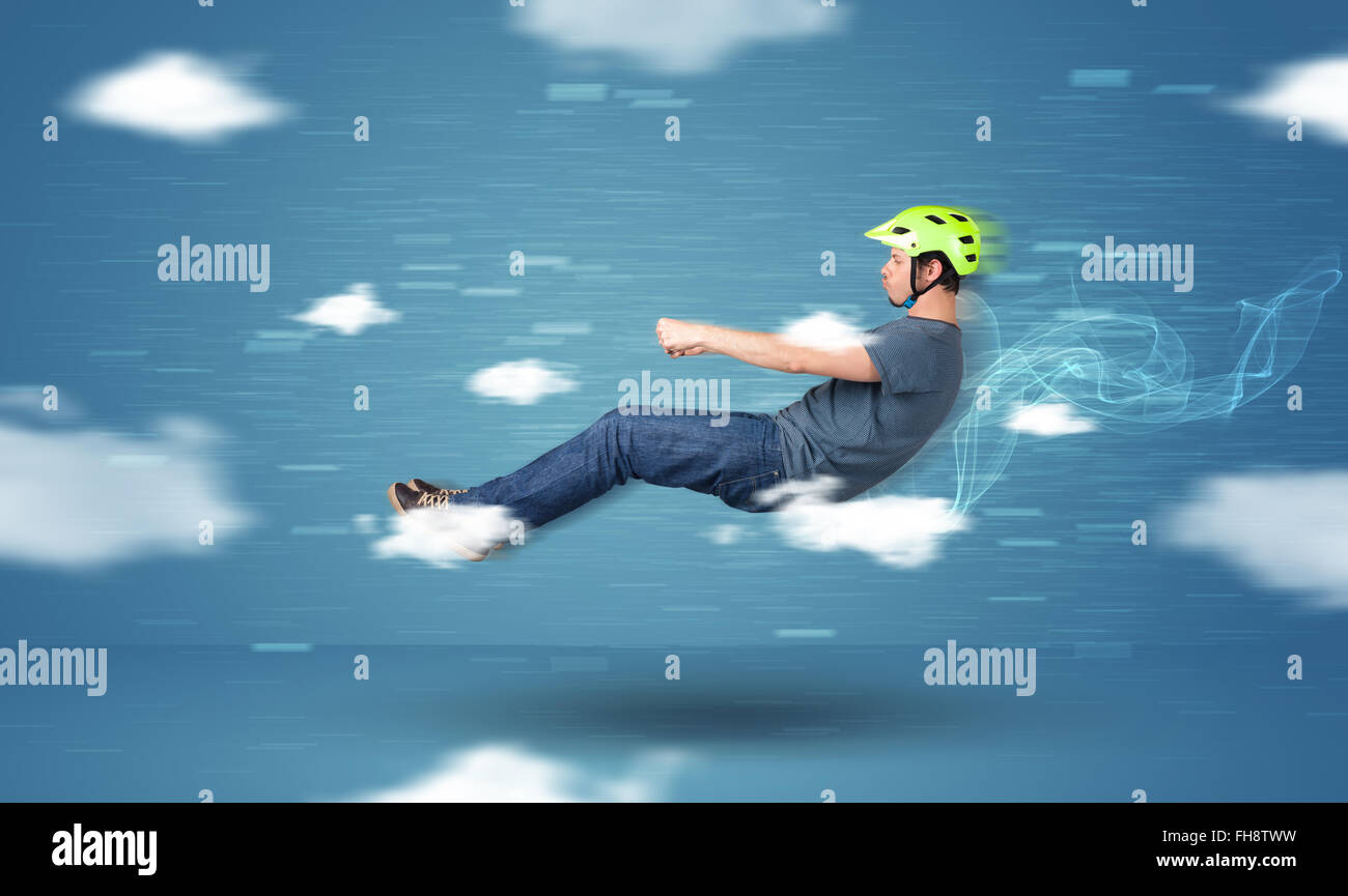 Funny racedriver young man driving between clouds concept Stock Photo