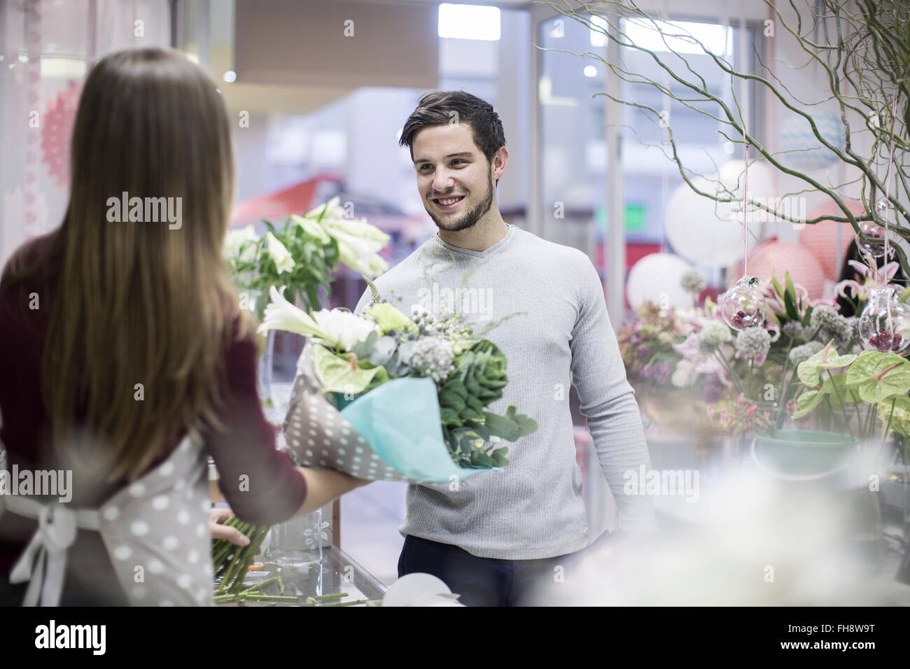 Man buying flowers in flower shop Stock Photo Alamy