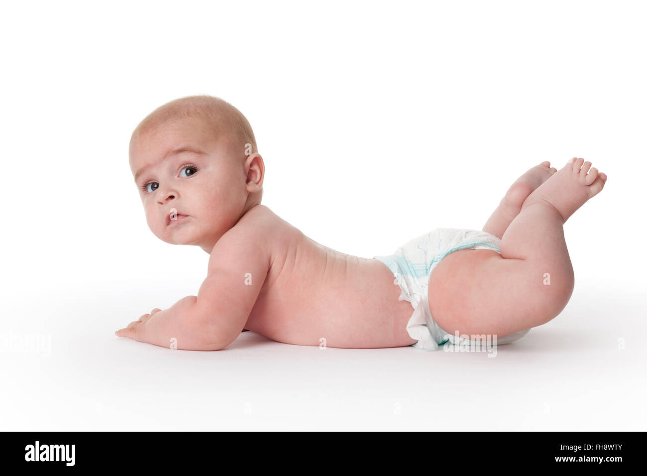 Baby boy lying on his belly full lenght on white background Stock Photo