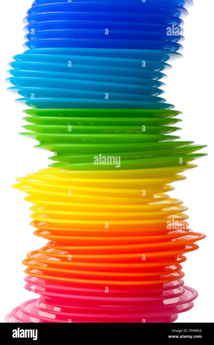 Rainbow colored plastic plates on white background Stock Photo