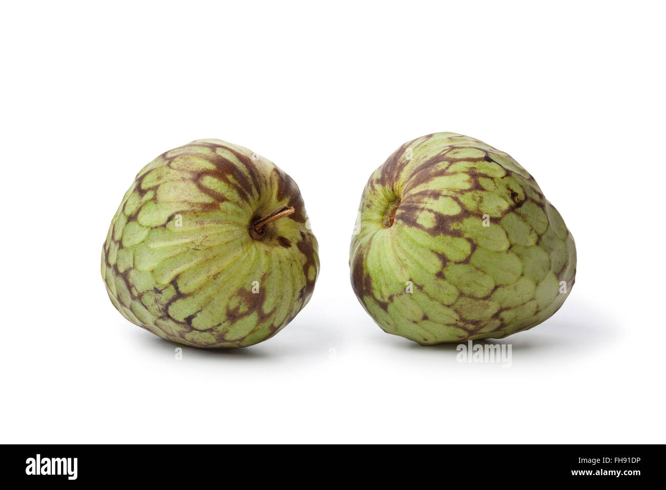 Pair of whole fresh Cherimoya fruit isolated on white background Stock Photo