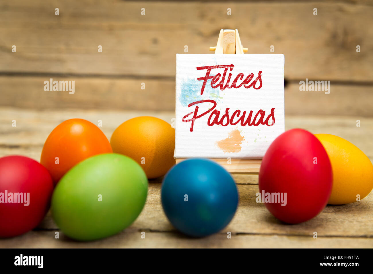 colorful easter eggs with canvas and spanish text, felices pascuas