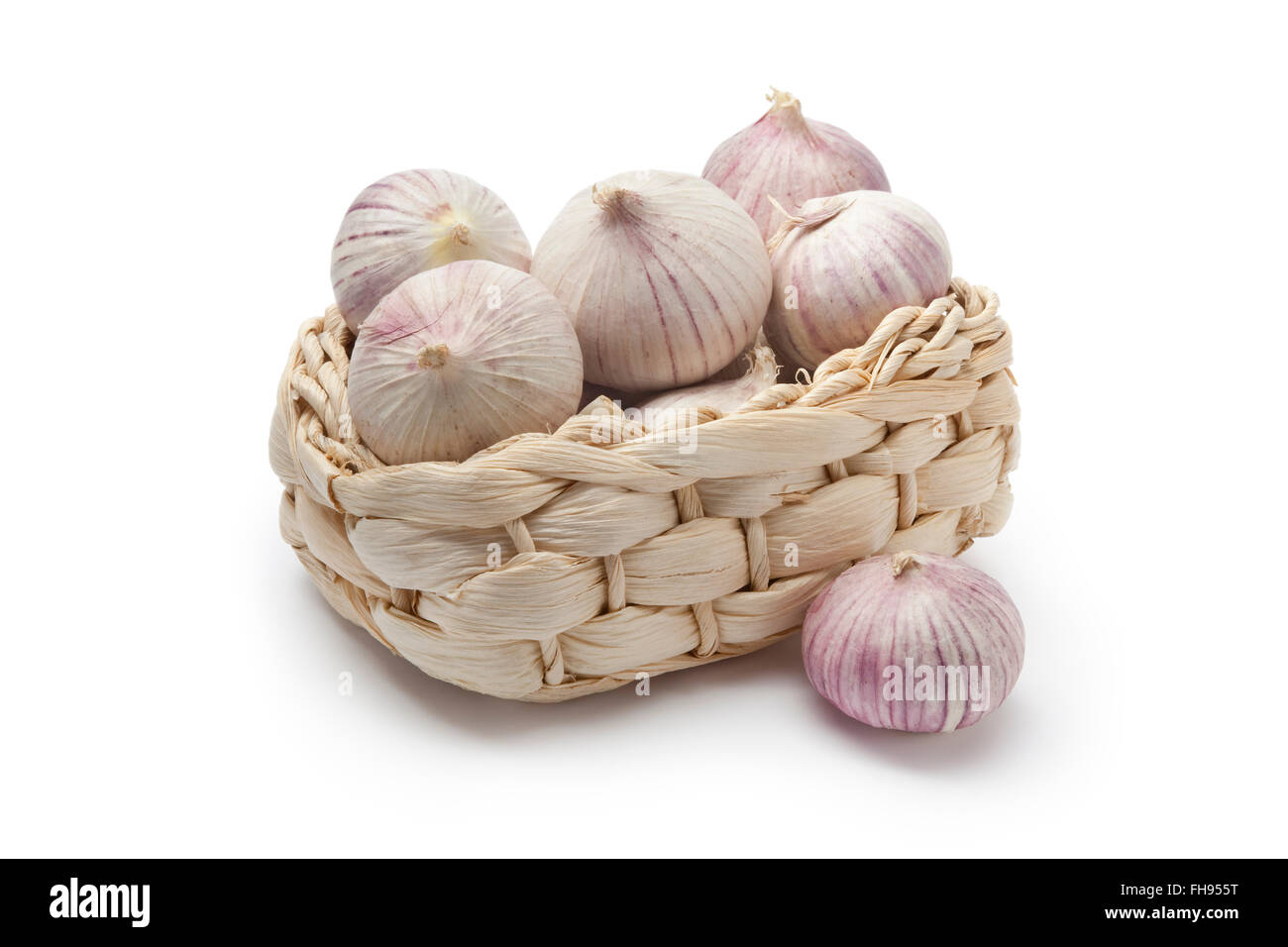 Basket with whole fresh single clove garlic on white background Stock Photo