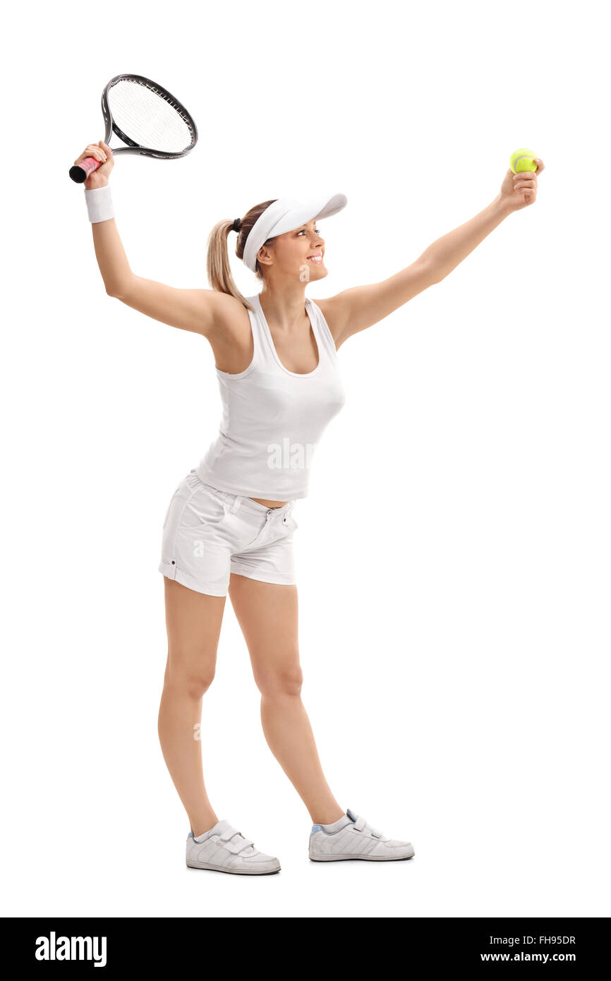 Full length profile shot of a female tennis player serving isolated on white background Stock Photo