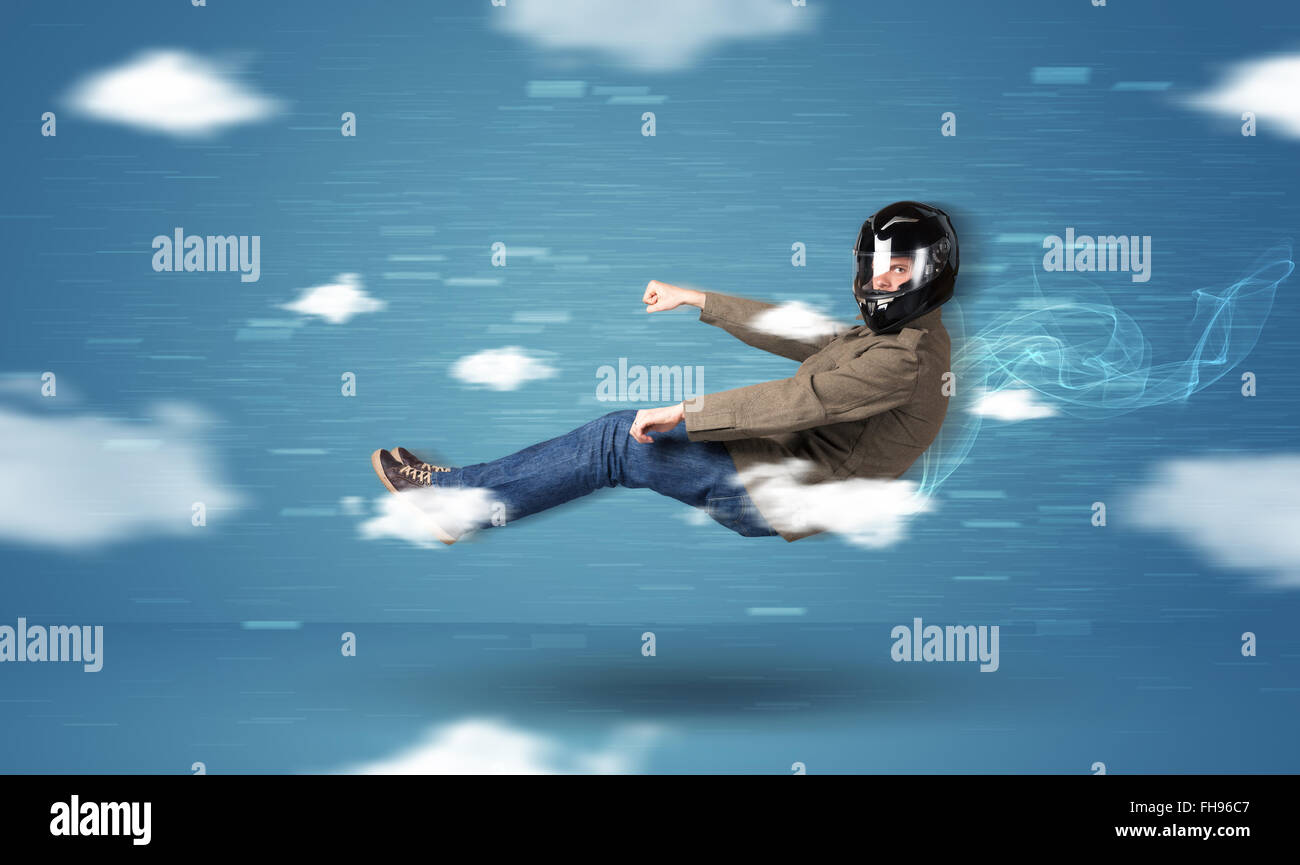 Funny racedriver young man driving between clouds concept Stock Photo