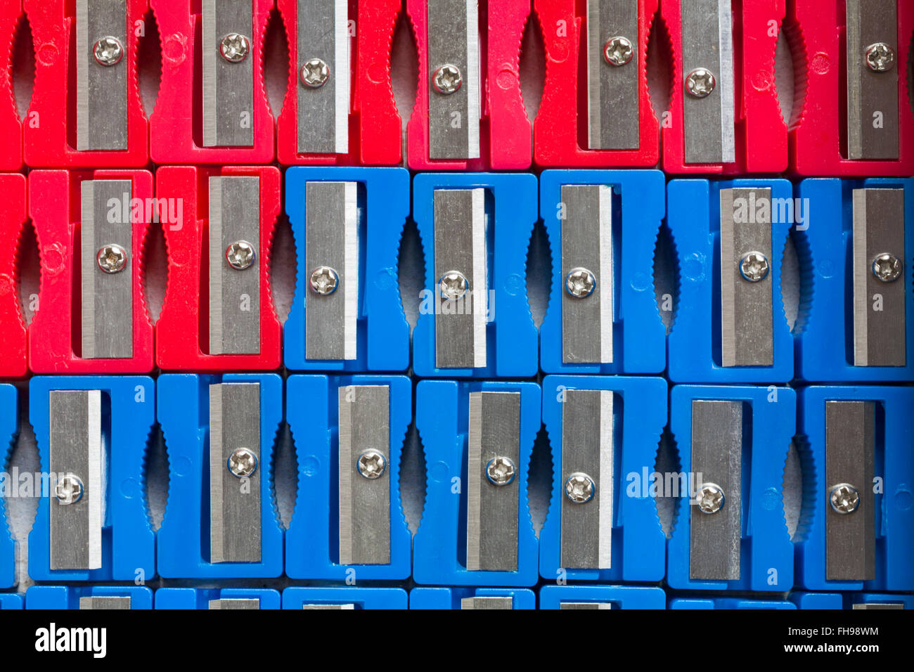 Rows of red and blue plastic pencil sharpeners Stock Photo
