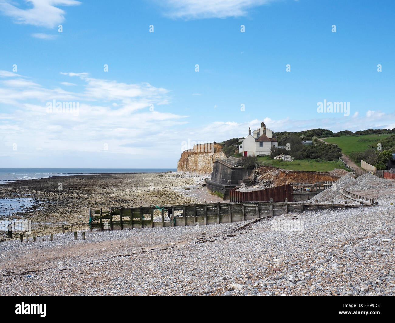 Cuckmere Haven coast guard cottages on the Sussex Coast under threat from coastal erosion Stock Photo