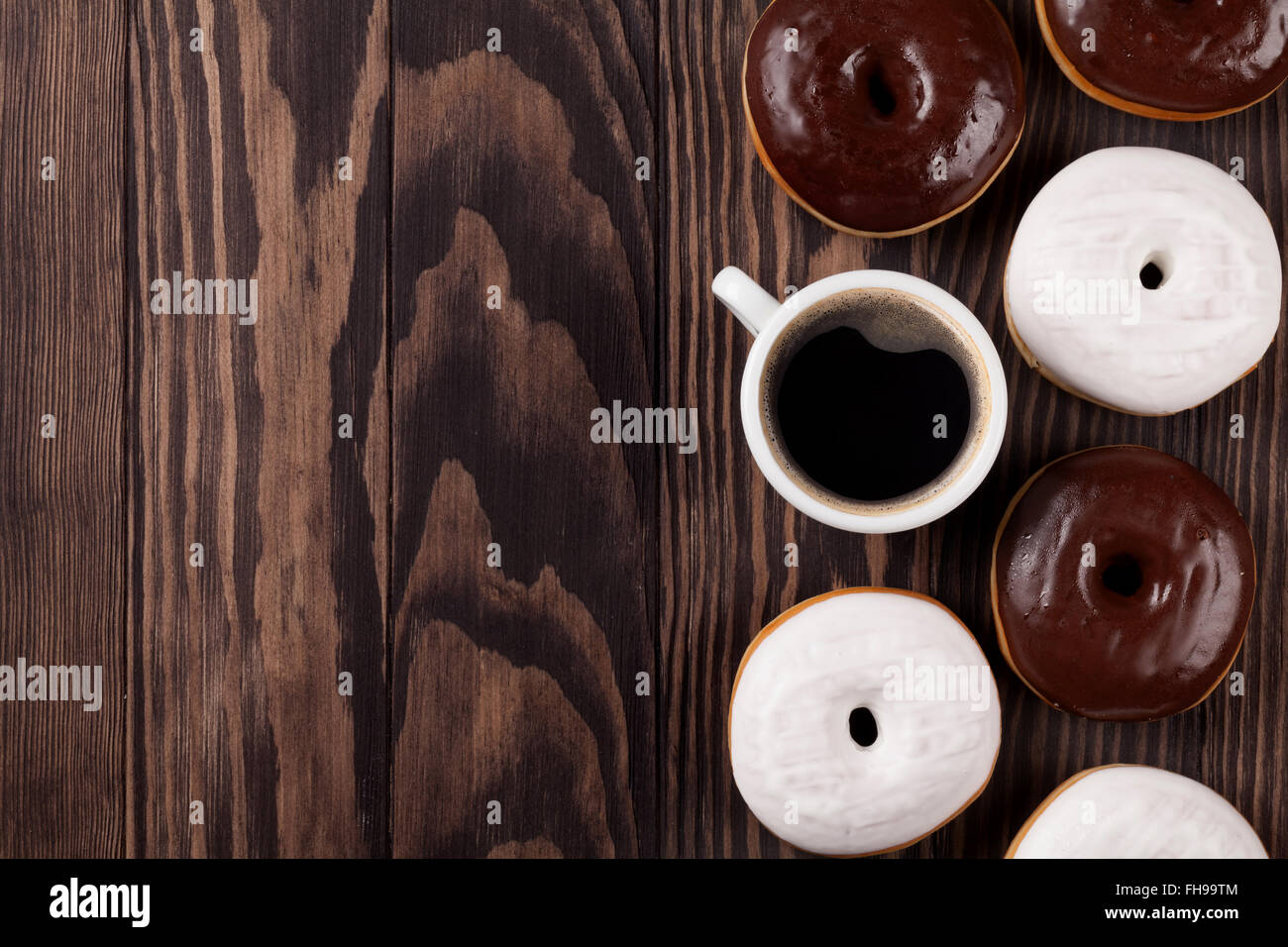 Donuts and coffee on wooden table. Top view with copy space Stock Photo ...