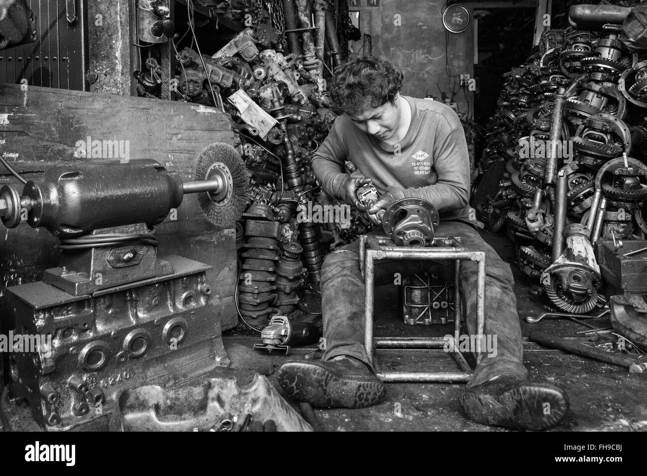 Car-part mechanic working in his shop in Bangkok, Thailand Stock Photo