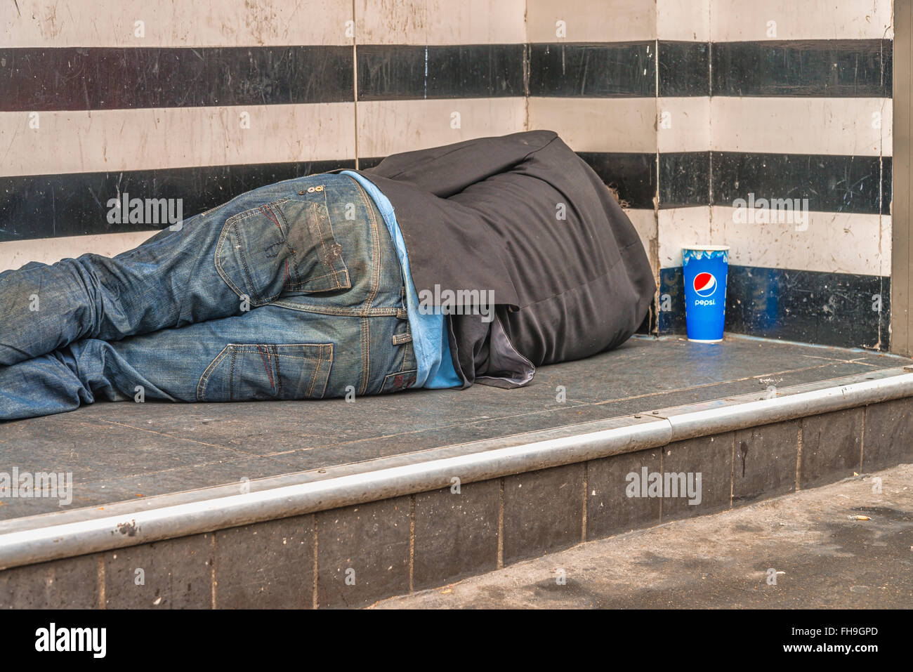 Homeless sleep on the street at the town Stock Photo