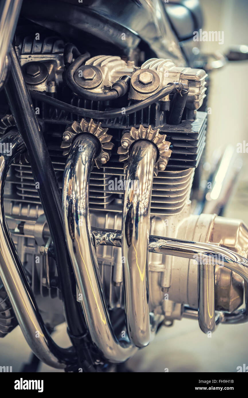 Aged motorcycle engine detail with chrome exhaust pipe Stock Photo - Alamy