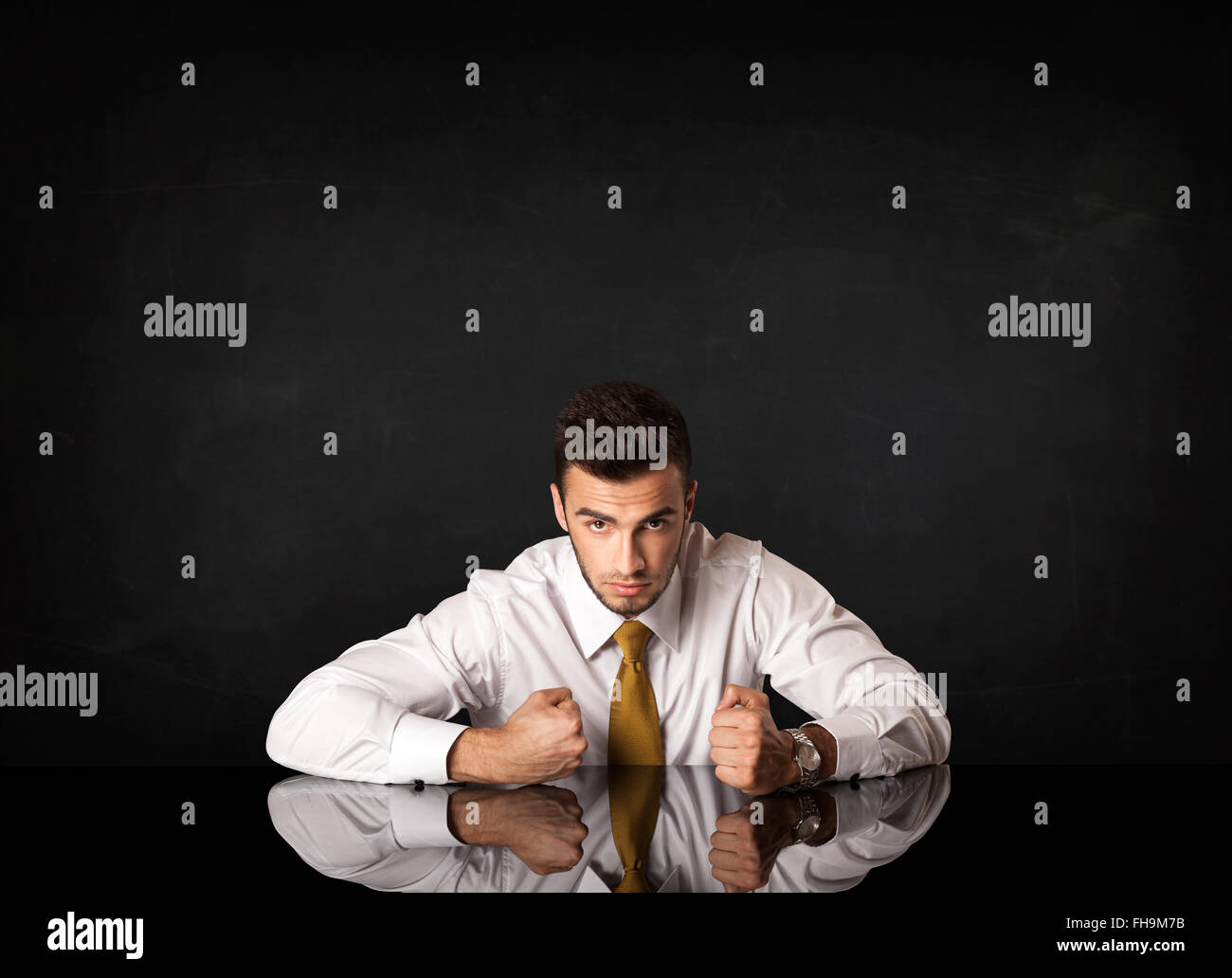 Businessman sitting at a desk Stock Photo - Alamy