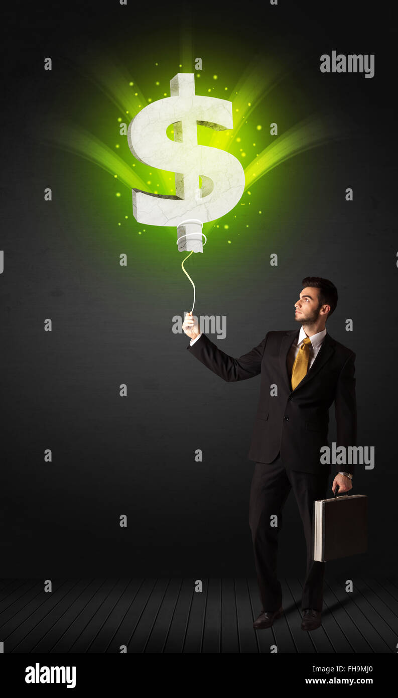 Businessman with a dollar sign balloon Stock Photo - Alamy