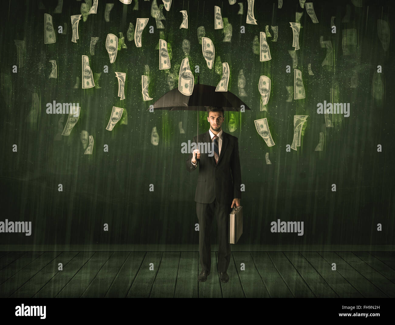 Businessman standing with umbrella in dollar bill rain concept Stock ...