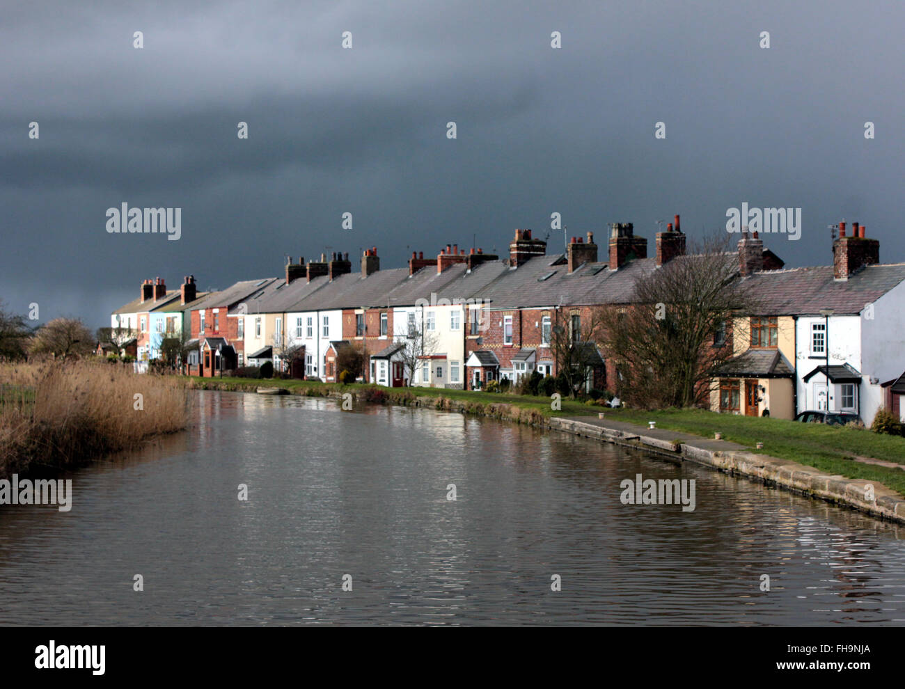 A Storm Brews Over Canal Side Cottages Alongside The Leeds And