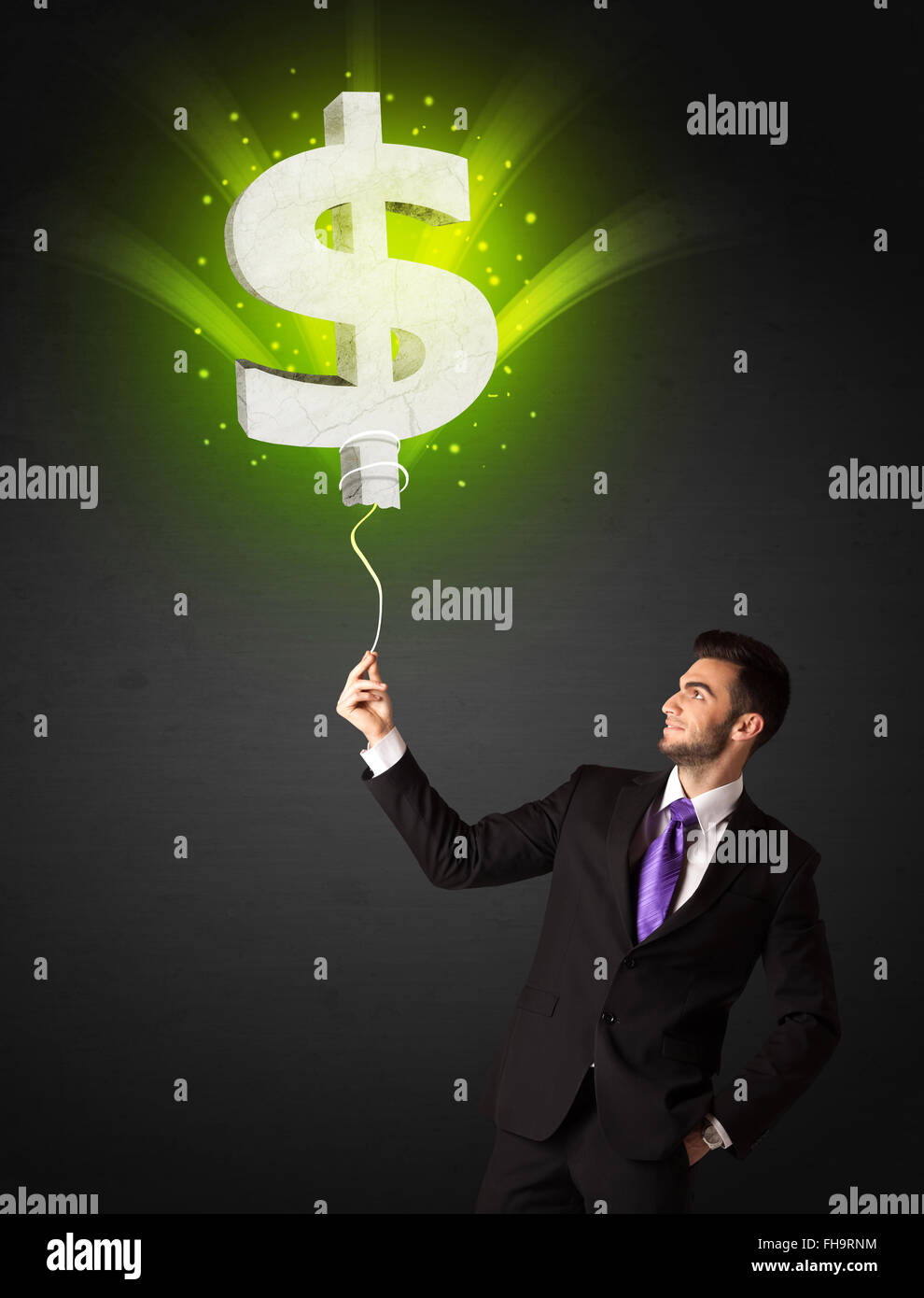 Businessman with a dollar sign balloon Stock Photo - Alamy