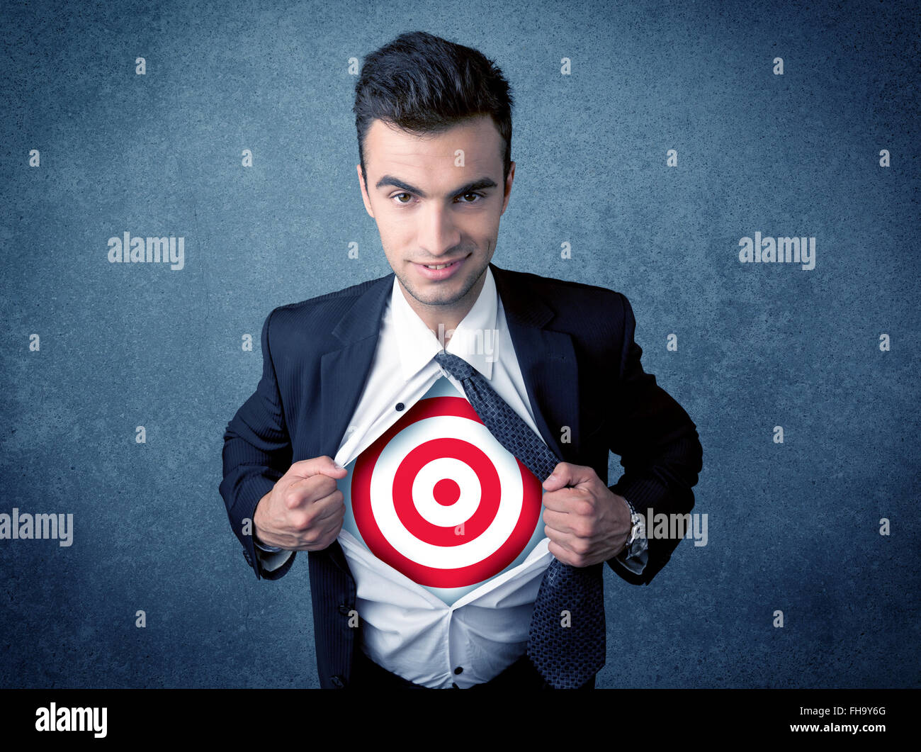 Businessman tearing shirt with target sign on his chest Stock Photo