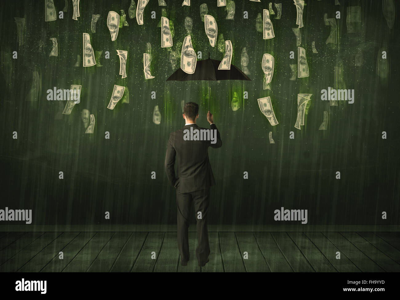 Businessman standing with umbrella in dollar bill rain concept Stock ...