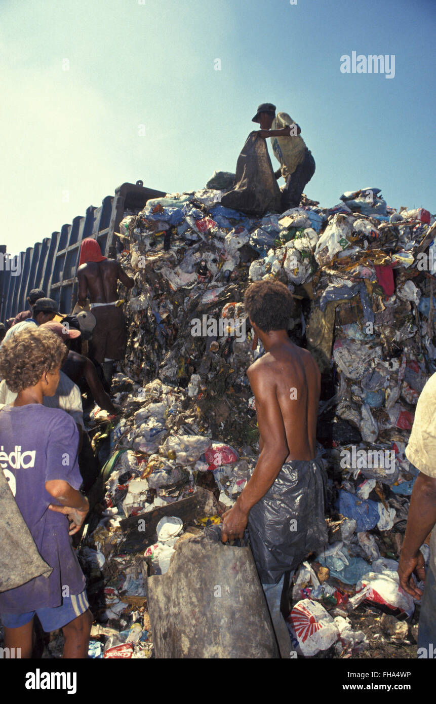 Child labor, pickers sort through garbage finding recyclables as a means of survival at Metropolitan Landfill of Jardim Gramacho (  Aterro Metropolitano de Jardim Gramacho ) in Duque de Caxias city, one of the largest landfills in the world, closed in June 2012 after 34 years of operation when it received most of the garbage produced in Rio de Janeiro city - it was started on an ecologically-sensitive wetland in the 1970s adjacent to Guanabara Bay. Stock Photo