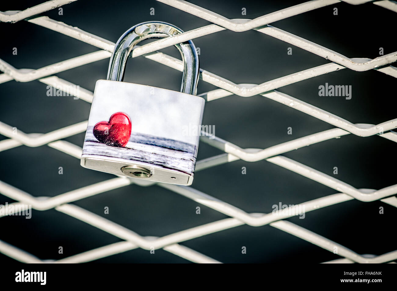 lock with red heart on railing of the bridge Stock Photo - Alamy