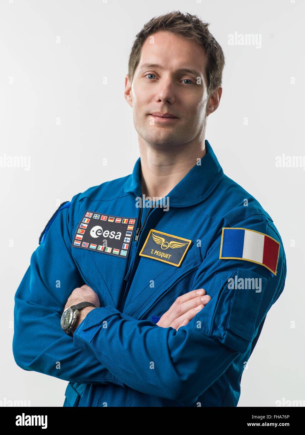 European Space Agency astronaut and Expedition 50/51 crew member Thomas Pesquet official portrait wearing the blue flight suit at the Johnson Space Center February 16, 2016 in Houston, Texas. Stock Photo