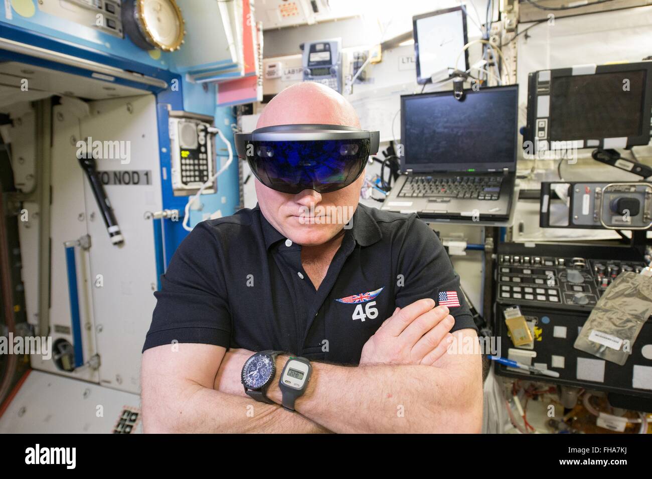 NASA astronaut Scott Kelly wearing virtual reality Microsoft HoloLens glasses aboard aboard the International Space Station February 20, 2016 in Earth Orbit. The device is part of NASA's project Sidekick which is exploring the use of augmented reality to reduce crew training requirements and increase the efficiency at which astronauts can work in space. Stock Photo