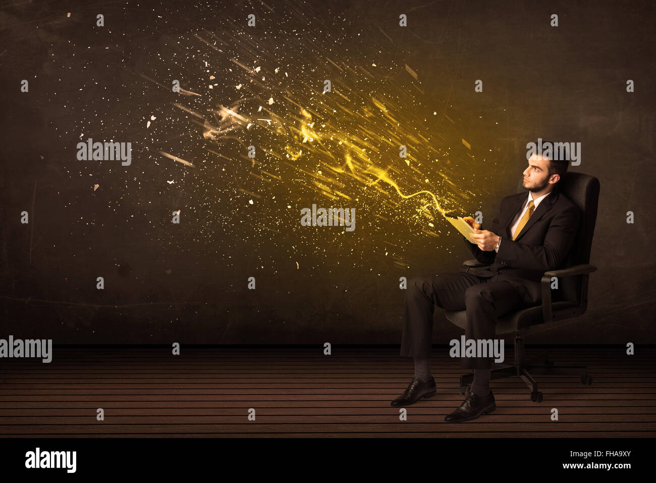 Businessman with tablet and energy explosion on background Stock Photo