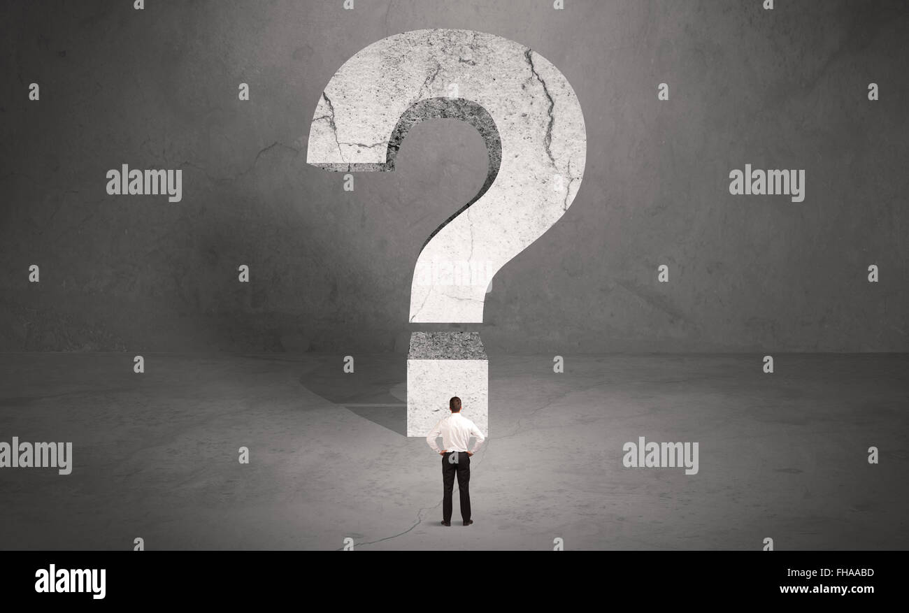 Confused businessman and big question mark Stock Photo