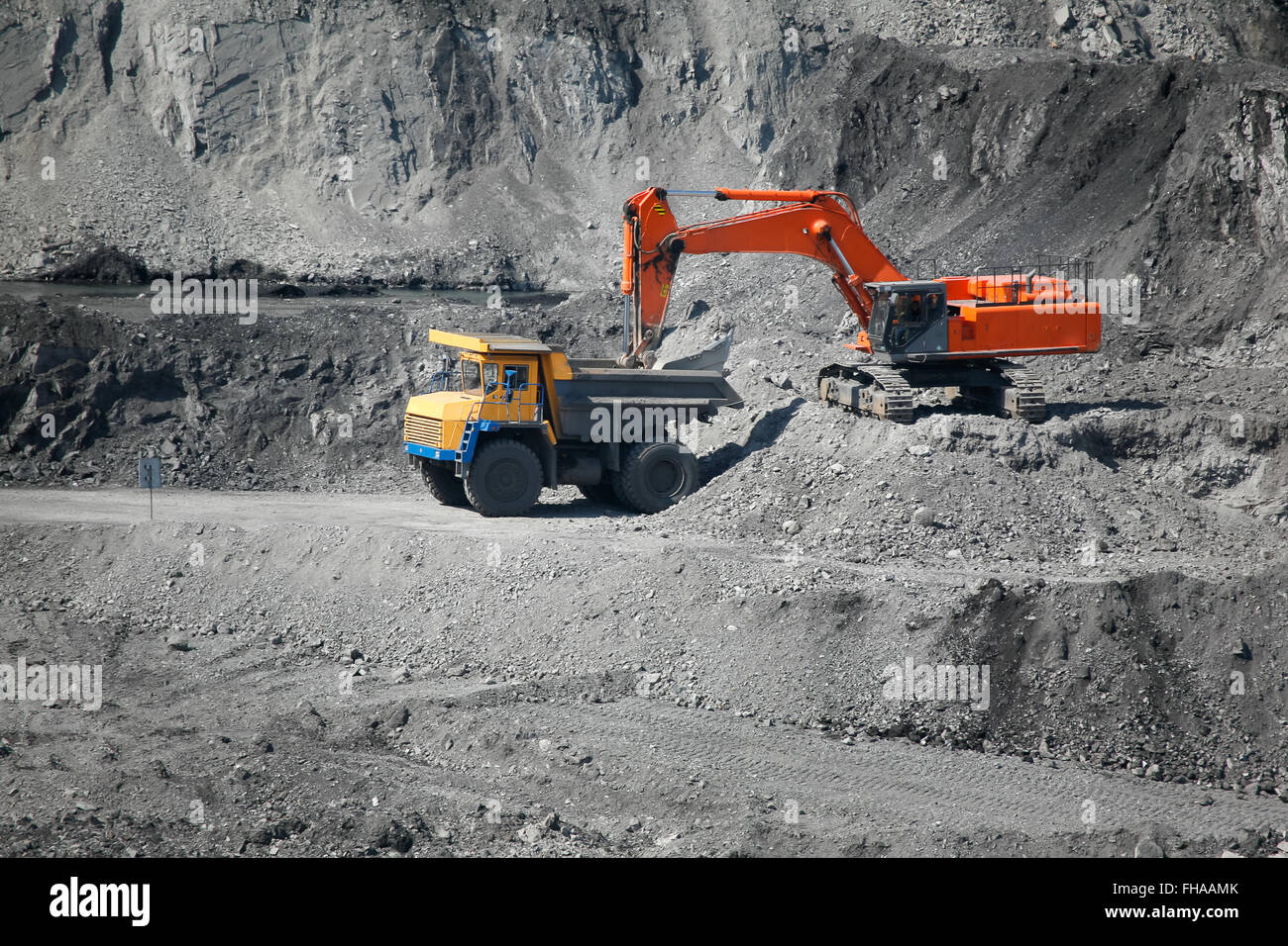 Excavator loading mining truck Stock Photo