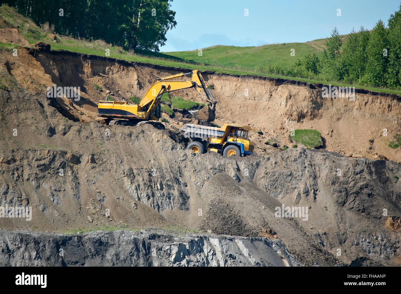 Excavator loading mining truck Stock Photo