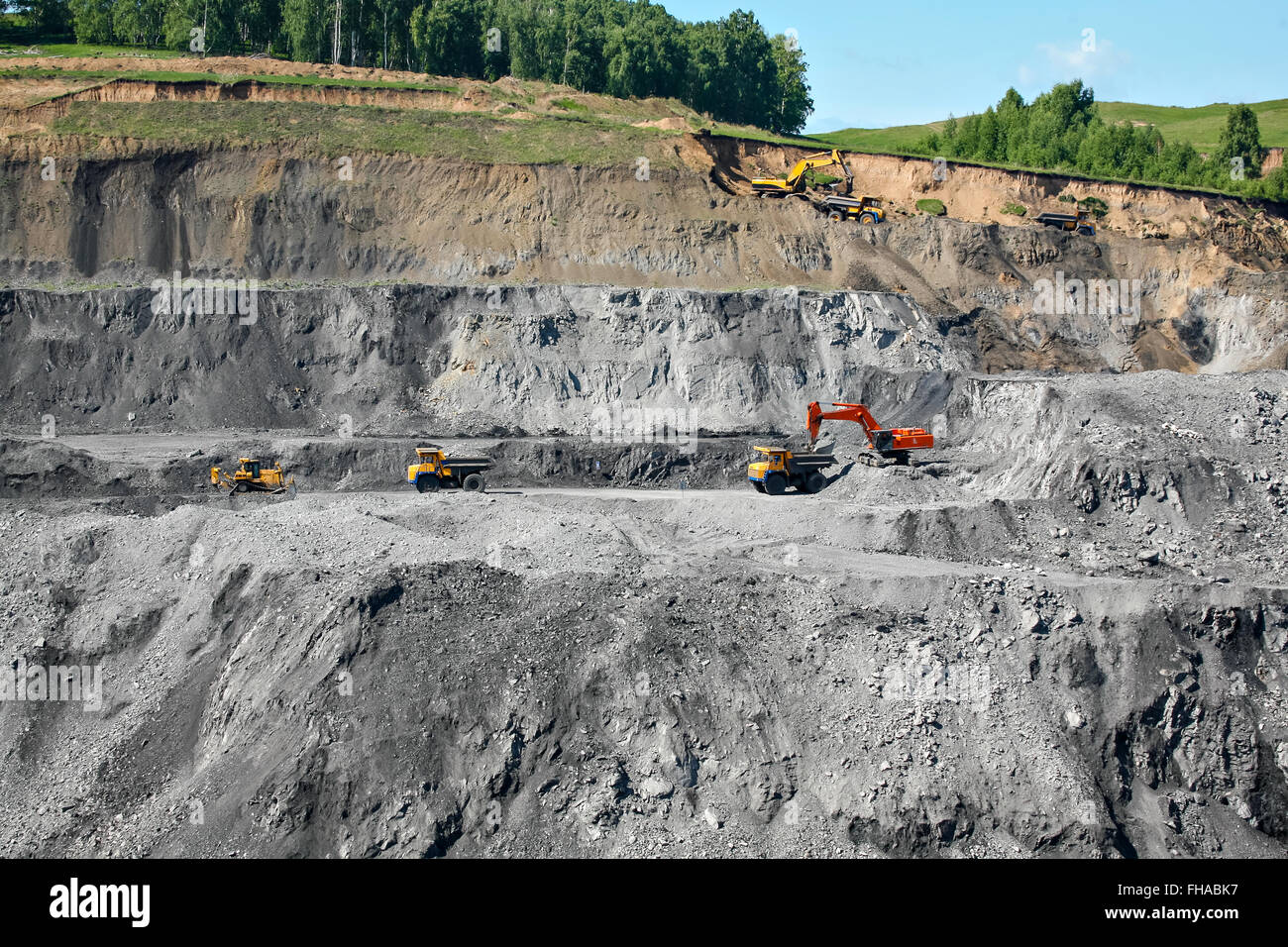 Excavator loading mining truck Stock Photo