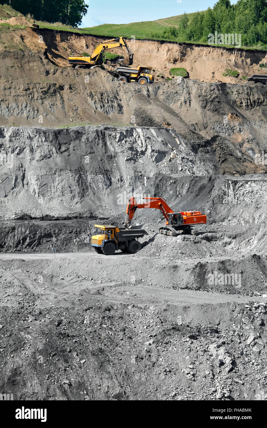 Excavator loading mining truck Stock Photo